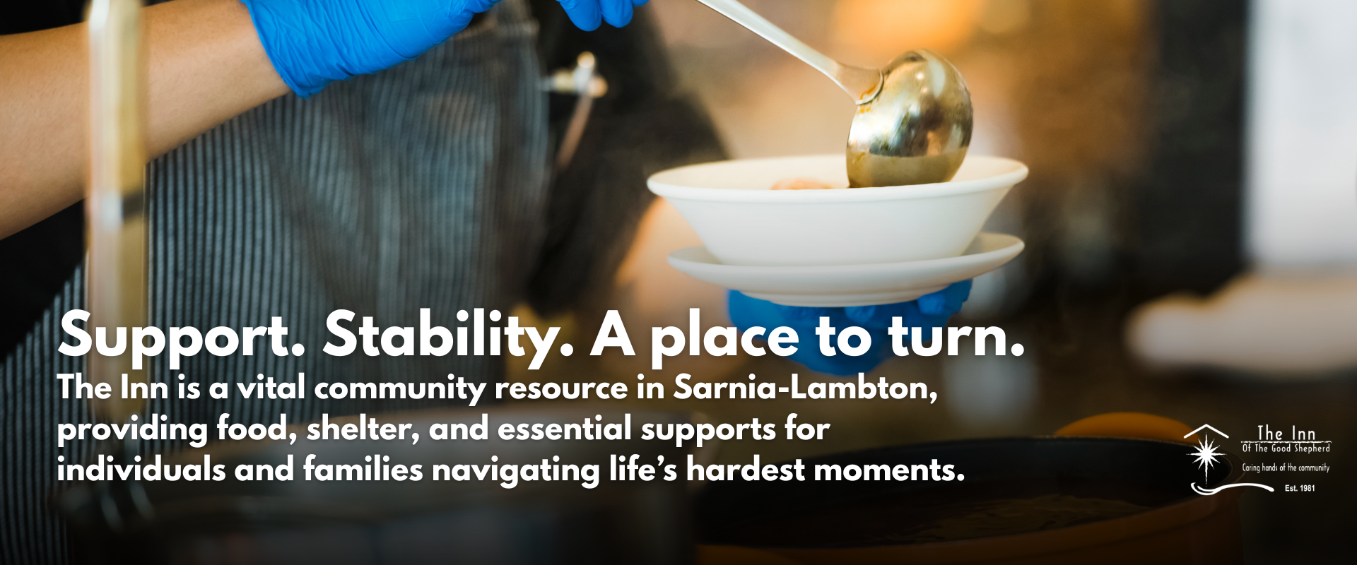 Person serving soup at the Inn's Soup Kitchen