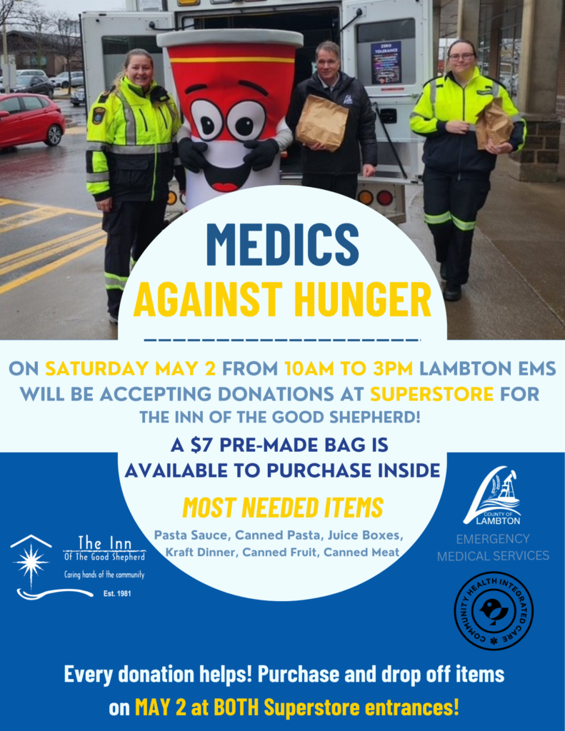 Poster promoting Medics Against Hunger in support of The Inn of the Good Shepherd. Features three Lambton EMS staff members standing beside an ambulance with a smiling donation mascot. Event takes place Saturday, May 2 from 10:00 AM to 3:00 PM at Superstore. Lambton EMS will be accepting donations, with $7 pre-made donation bags available for purchase inside. Most needed items include pasta sauce, canned pasta, juice boxes, Kraft Dinner, canned fruit, and canned meat. Logos for The Inn and County of Lambton Emergency Medical Services are displayed.